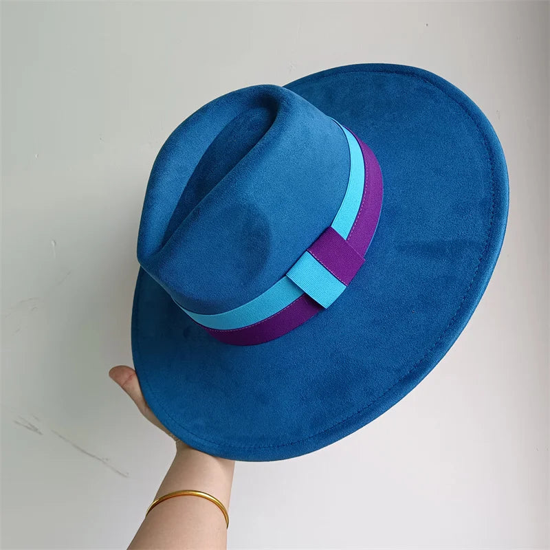 Blue fedora hat with colorful bands held by a hand against a light gray background