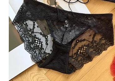 Black lace underwear on a wooden surface