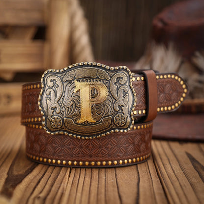 Brown leather belt with gold and silver buckle featuring a letter 'P' on a wooden surface.