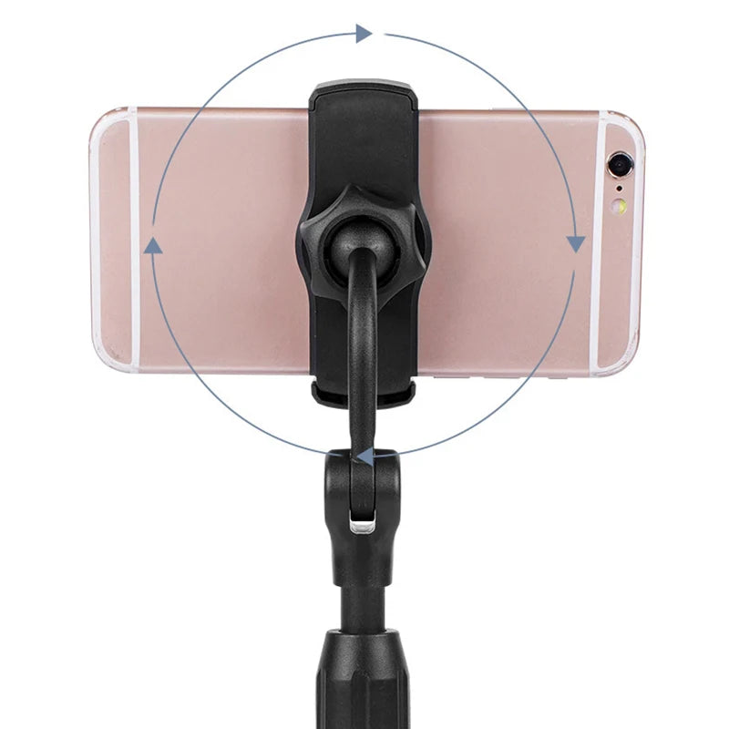Phone holder with a smartphone on a white background. Aluminum alloy desktop tripod phone holder stand bracket for iPhone & smartphones. Portable stable tripod perfect for photography, video, live calls.