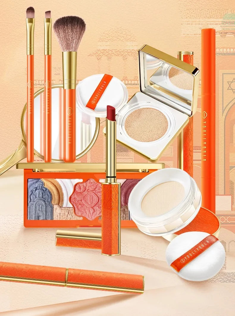 Makeup set with orange and gold accents on a beige background. Christmas makeup gift box with BB cream, lipstick, eyeshadow, eyebrow pencil, and brushes. Holiday beauty set for women & girls.