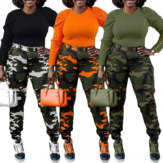 Three women wearing camouflage pants with different colored tops and shoes, holding handbags.