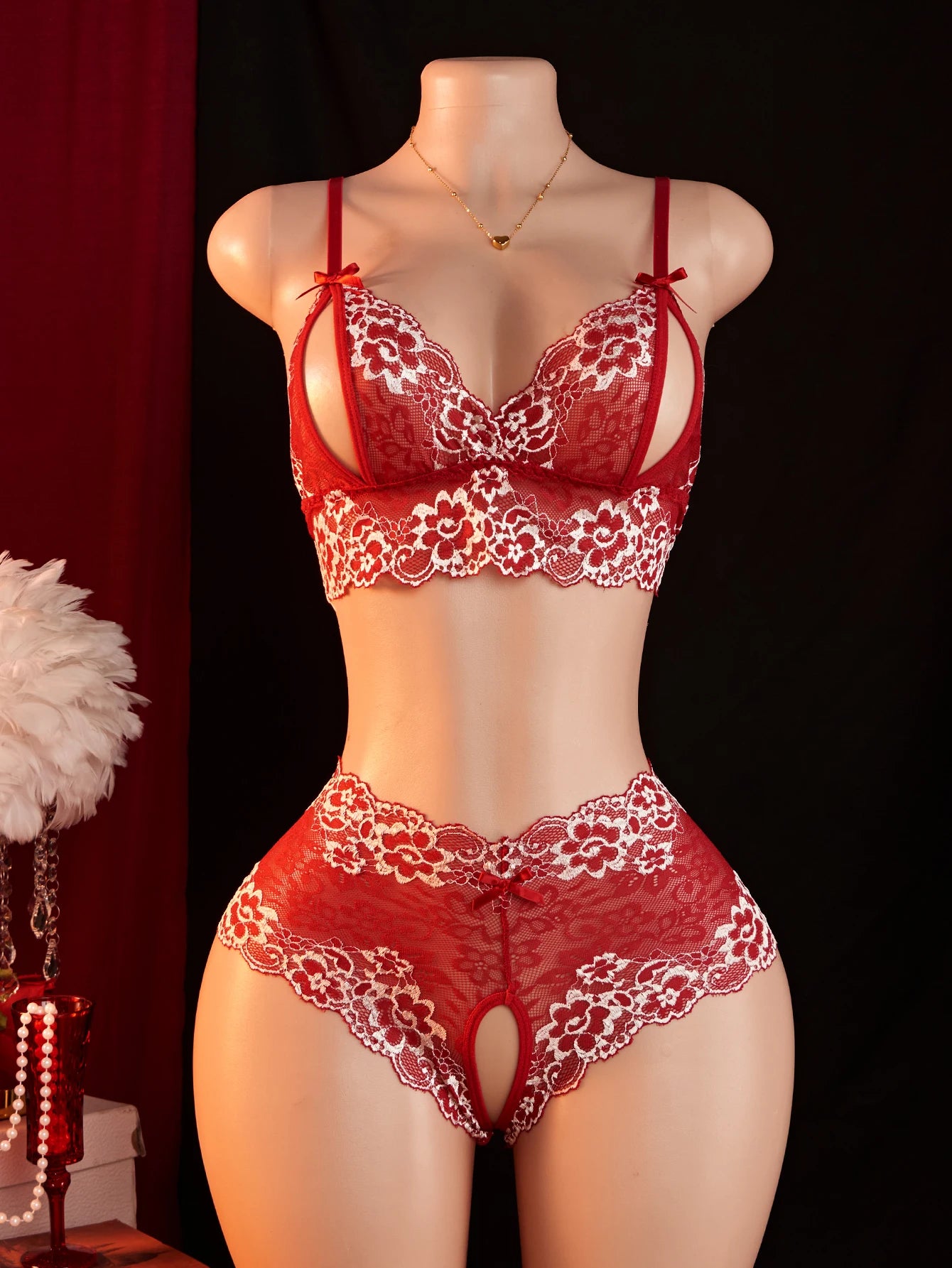 Red lace lingerie set on a mannequin against a dark background