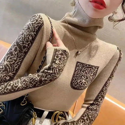 Close-up of a person wearing a beige sweater with leopard print sleeves and pocket.