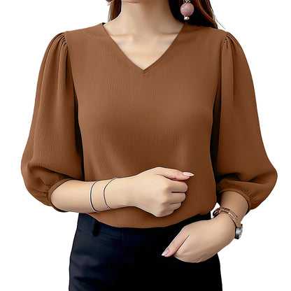 Brown blouse worn by a person on a white background