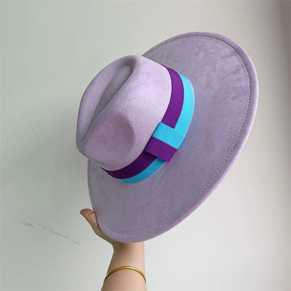 Purple hat with a blue and purple band held by a hand against a light gray background
