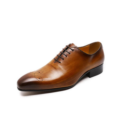 Brown leather dress shoe on a white background