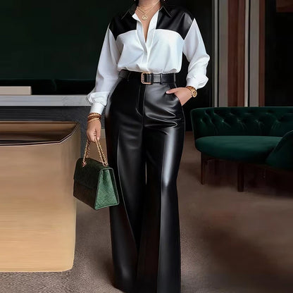 Person wearing a black and white outfit with leather pants and holding a green handbag in an indoor setting.