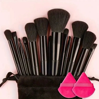 Set of makeup brushes with black handles and brown bristles, accompanied by two pink silicone sponges on a light pink background. Soft fluffy makeup brush set with wool fiber bristles and plastic handles. Complete set for powder, foundation, eyeshadow, and beauty blending.