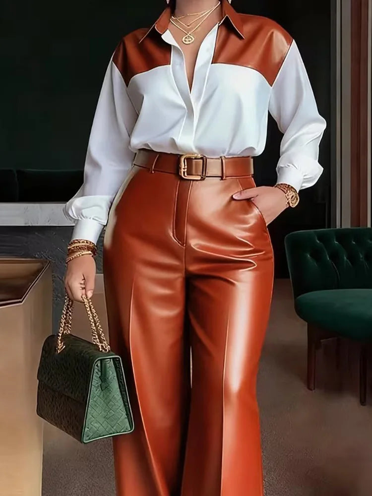 Person wearing a white shirt with brown accents and red pants, holding a green handbag.
