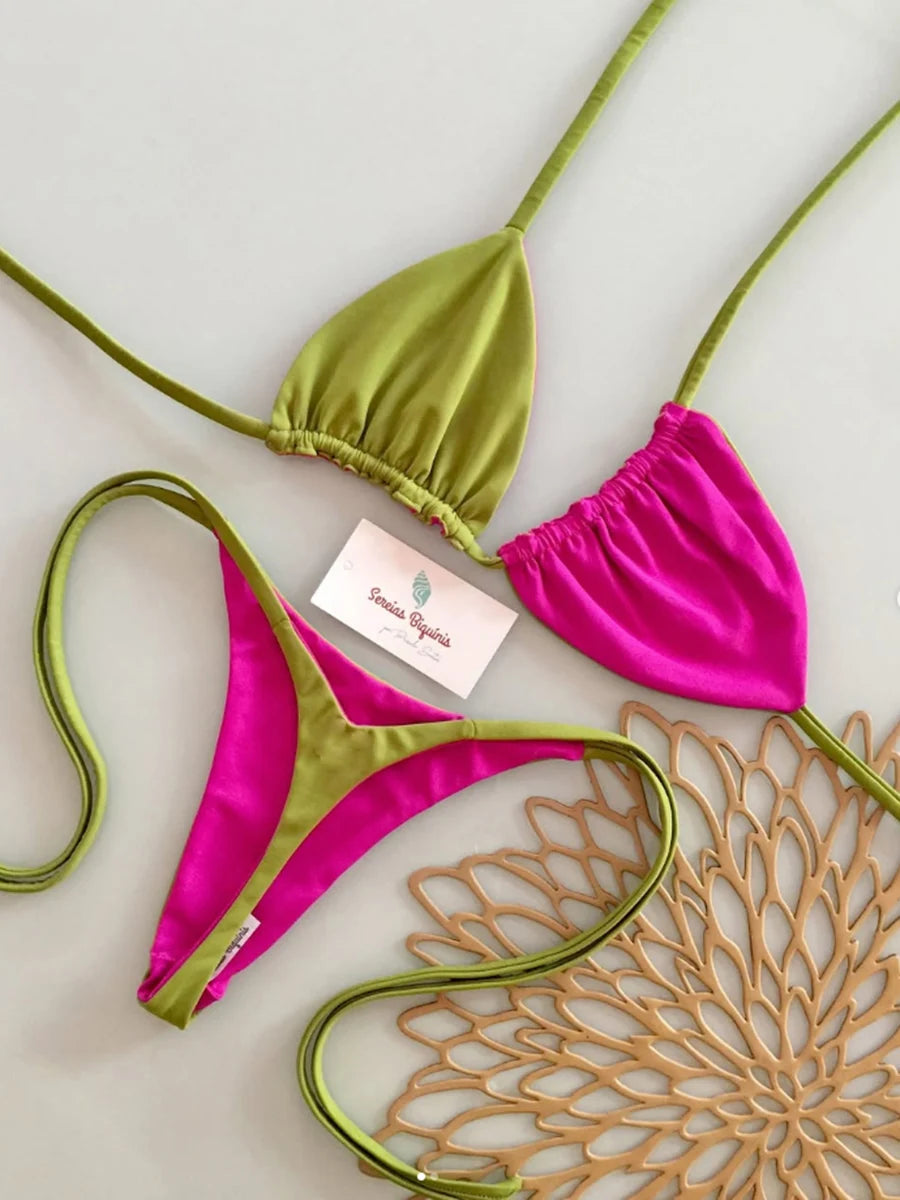 Green and pink bikini set with a brand card on a light background