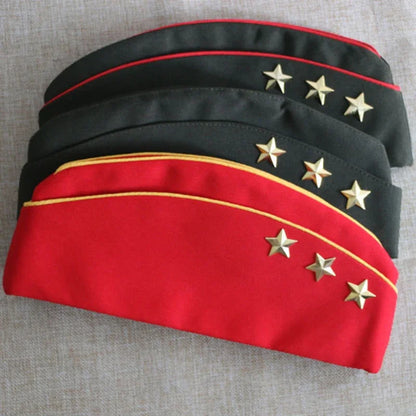 Two military-style hats with gold stars on a textured surface