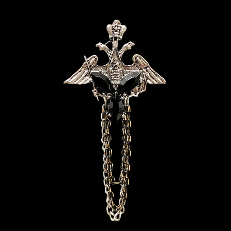 Decorative brooch with wings and chain on a black background. Elegant rhinestone lapel pins for men and women. Tassel, crown, floral pins for suits, collars, weddings, parties. Zinc alloy metal, classic style.