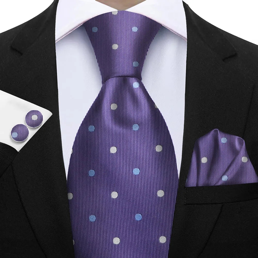 Man wearing a black suit with a purple tie, pocket square, and cufflinks featuring white polka dots. Elegant men’s 3-piece tie set: striped necktie, floral pocket square, matching cufflinks. Fashionable polyester accessories for formal occasions.