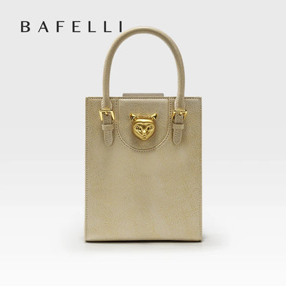 Beige handbag with gold accents and 'Bafelli' branding on a light gray background. Unisex mini tote crossbody bag in split leather with flap pocket and lock closure. Hard box shape and polyester lining. Casual versatile style.