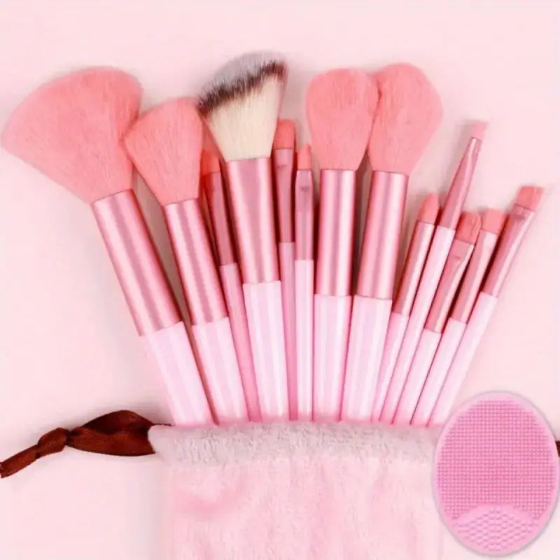 Set of pink makeup brushes with a carrying case on a light pink background. Soft fluffy makeup brush set with wool fiber bristles and plastic handles. Complete set for powder, foundation, eyeshadow, and beauty blending.