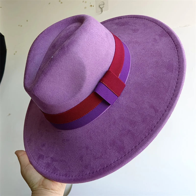 Purple hat with a red and purple band held by a hand against a white background