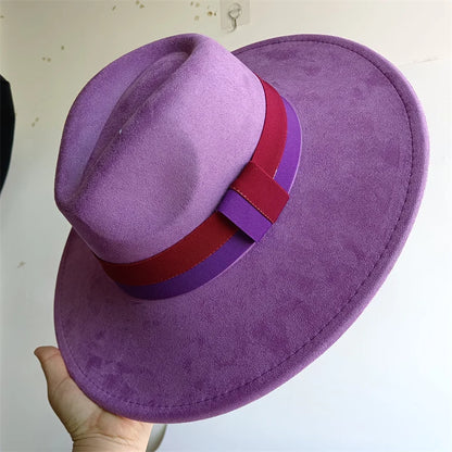Purple hat with a red and purple band held by a hand against a white background