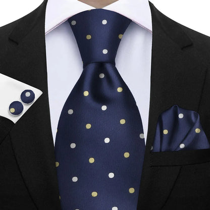 Navy blue tie with gold polka dots worn with a black suit, white shirt, and matching pocket square. Elegant men’s 3-piece tie set: striped necktie, floral pocket square, matching cufflinks. Fashionable polyester accessories for formal occasions.