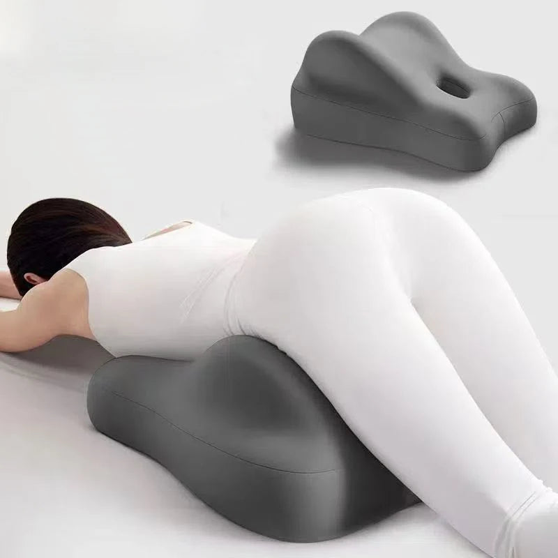 Person using a gray ergonomic pillow on a white background