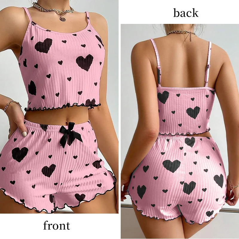 Pink romper with black heart patterns shown from front and back views. Soft women’s pajama set, 2 pieces white tank top and shorts, breathable fabric with love print, comfortable casual sleepwear, UK FTF Market.