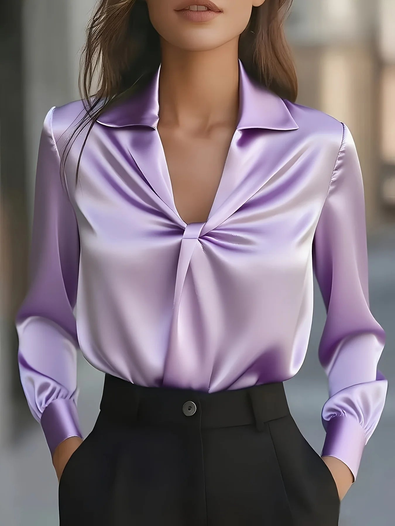 Purple satin blouse with a knot detail worn by a person, blurred background
