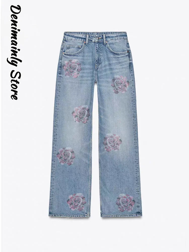 Light blue jeans with floral embroidery on a white background, branded 'Denimainly Store'. Women’s denim jeans with flower rhinestones, loose wide leg, low waist, light wash. Stylish rhinestone casual trousers for UK fashion lovers.