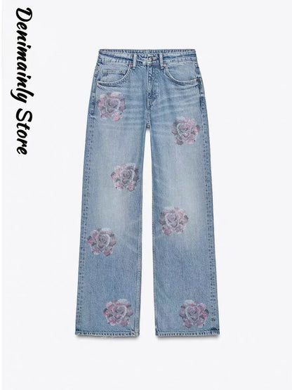 Light blue jeans with floral embroidery on a white background, branded 'Denimainly Store'. Women’s denim jeans with flower rhinestones, loose wide leg, low waist, light wash. Stylish rhinestone casual trousers for UK fashion lovers.