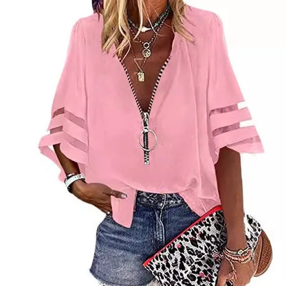 Person wearing a pink zip-up top with denim shorts and a leopard print bag.