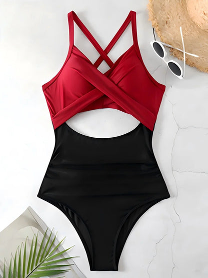 Black and red swimsuit with sunglasses and a hat on a light background