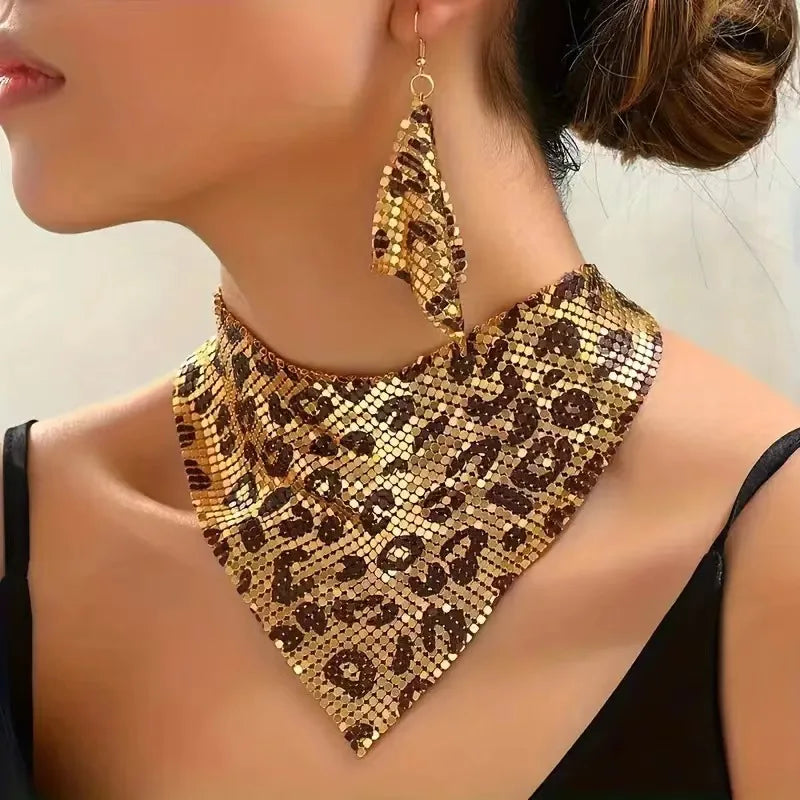 Leopard print necklace and earrings on a person against a neutral background. Women’s fashion jewelry set with leopard print triangle scarf necklace and sparkling drop earrings, perfect for parties and stylish events.