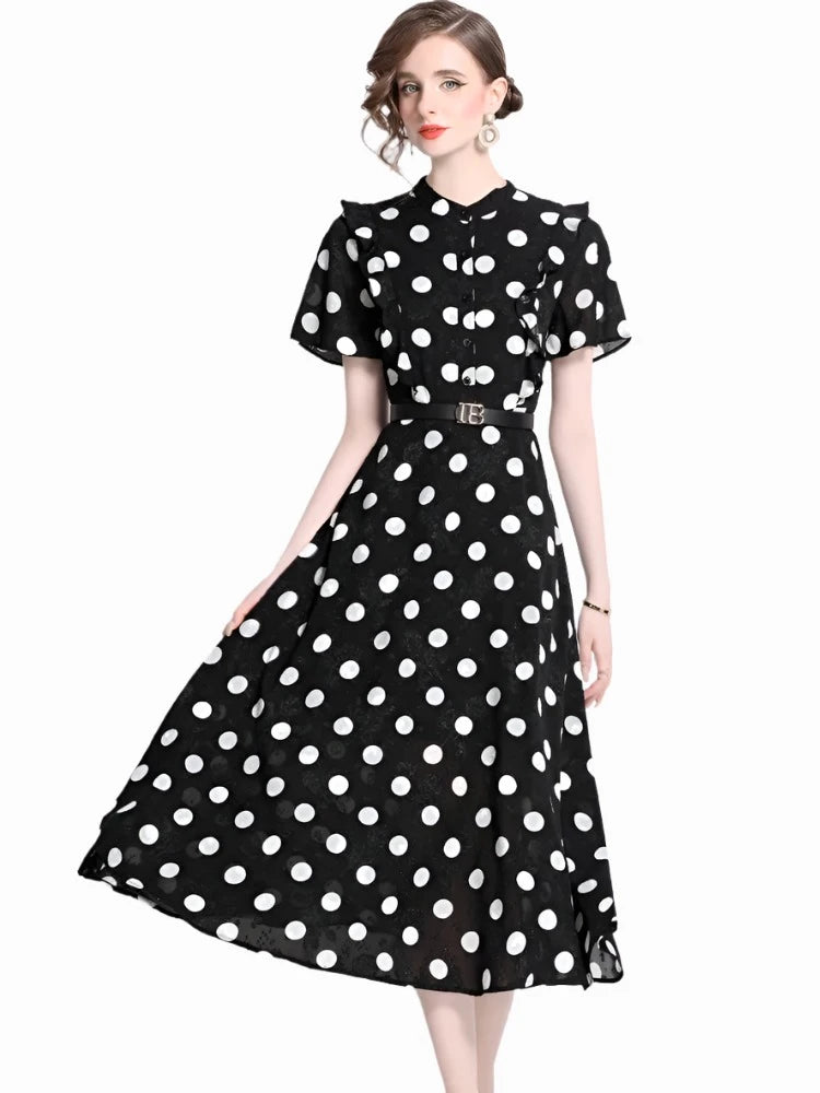 A woman wearing an elegant polka dot dress