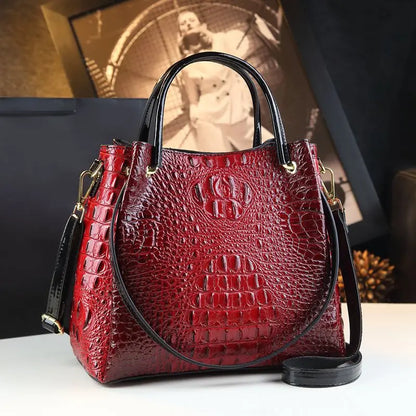 Red textured handbag with black handle and strap on a white surface. Vintage genuine leather bucket tote bag with crocodile print. Soft medium-hardness leather, zipper closure, interior pockets. Stylish crossbody bag UK.
