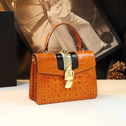 Brown crocodile-patterned handbag with gold lock on a white surface, blurred vintage photo in the background. Small genuine leather crocodile crossbody bag. Hard flap design with soft handle, zipper closure, and interior phone & compartment pockets.