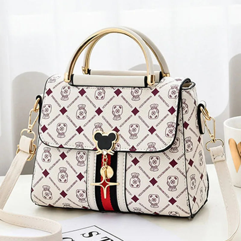 Designer handbag with brand logo on a white surface