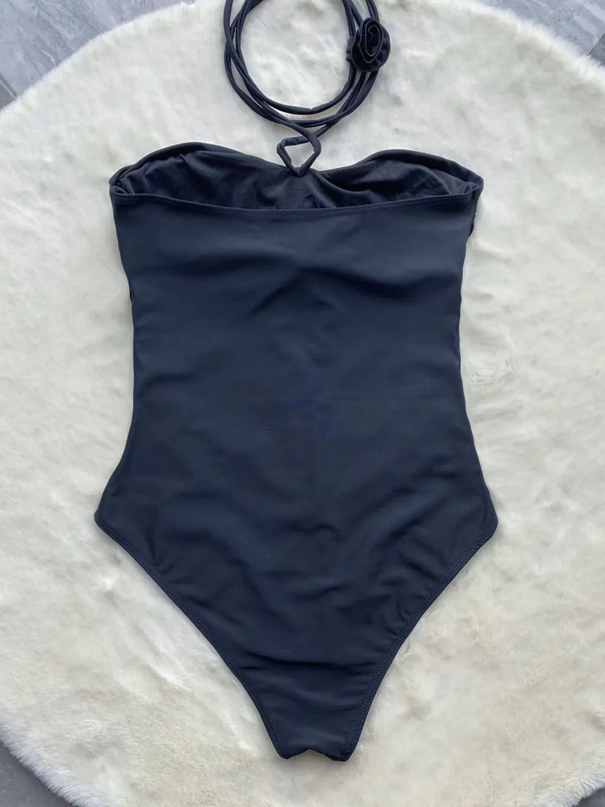 Black hollow-out monokini back view flat lay — one-piece swimsuit women sizes S M L