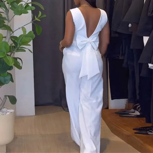 Person wearing a white dress with a large bow at the back in an indoor setting. Women’s striped print blouse and elastic waist pants two-piece suit. Sleek, comfortable, breathable office wear perfect for spring and summer.