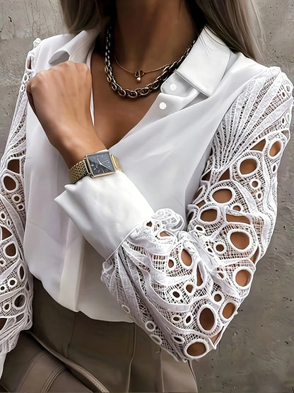 White blouse with lace sleeves and a watch on a neutral background