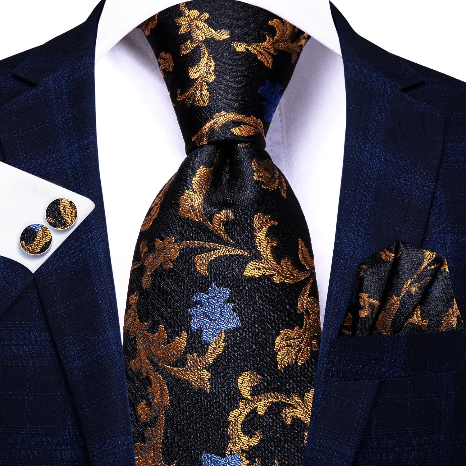 Navy blue suit with gold floral tie, pocket square, and cufflinks on a white background. Men’s luxury paisley silk tie and pocket square set, 8.5cm wide, for business or wedding. Red formal necktie, ftf fashion UK.
