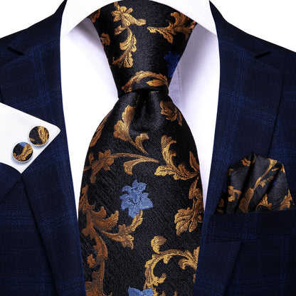 Navy blue suit with gold floral tie, pocket square, and cufflinks on a white background. Men’s luxury paisley silk tie and pocket square set, 8.5cm wide, for business or wedding. Red formal necktie, ftf fashion UK.