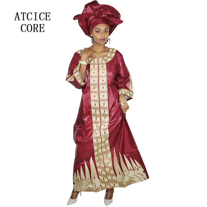 Woman wearing a red and gold traditional outfit with a matching headwrap on a white background.