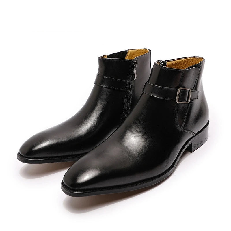 Pair of black leather boots with buckle details on a white background