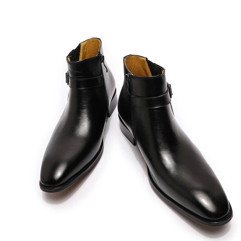 Pair of black leather boots on a white background
