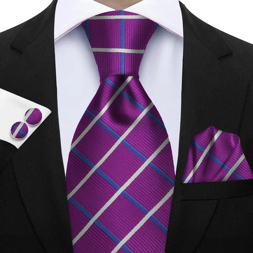 Purple striped tie with matching pocket square and cufflinks on a suit. Elegant men’s 3-piece tie set: striped necktie, floral pocket square, matching cufflinks. Fashionable polyester accessories for formal occasions.