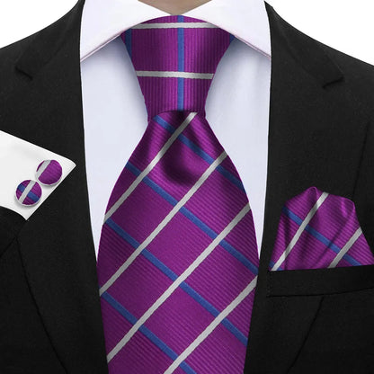 Purple striped tie with matching pocket square and cufflinks on a suit. Elegant men’s 3-piece tie set: striped necktie, floral pocket square, matching cufflinks. Fashionable polyester accessories for formal occasions.