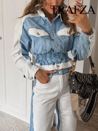 Person wearing a blue and white denim jacket and pants, holding a black handbag with visible branding. Women’s 2-piece denim jacket and straight jeans set. Patchwork design, mid waist, turn-down collar, button closure, loose casual fit, streetwear.