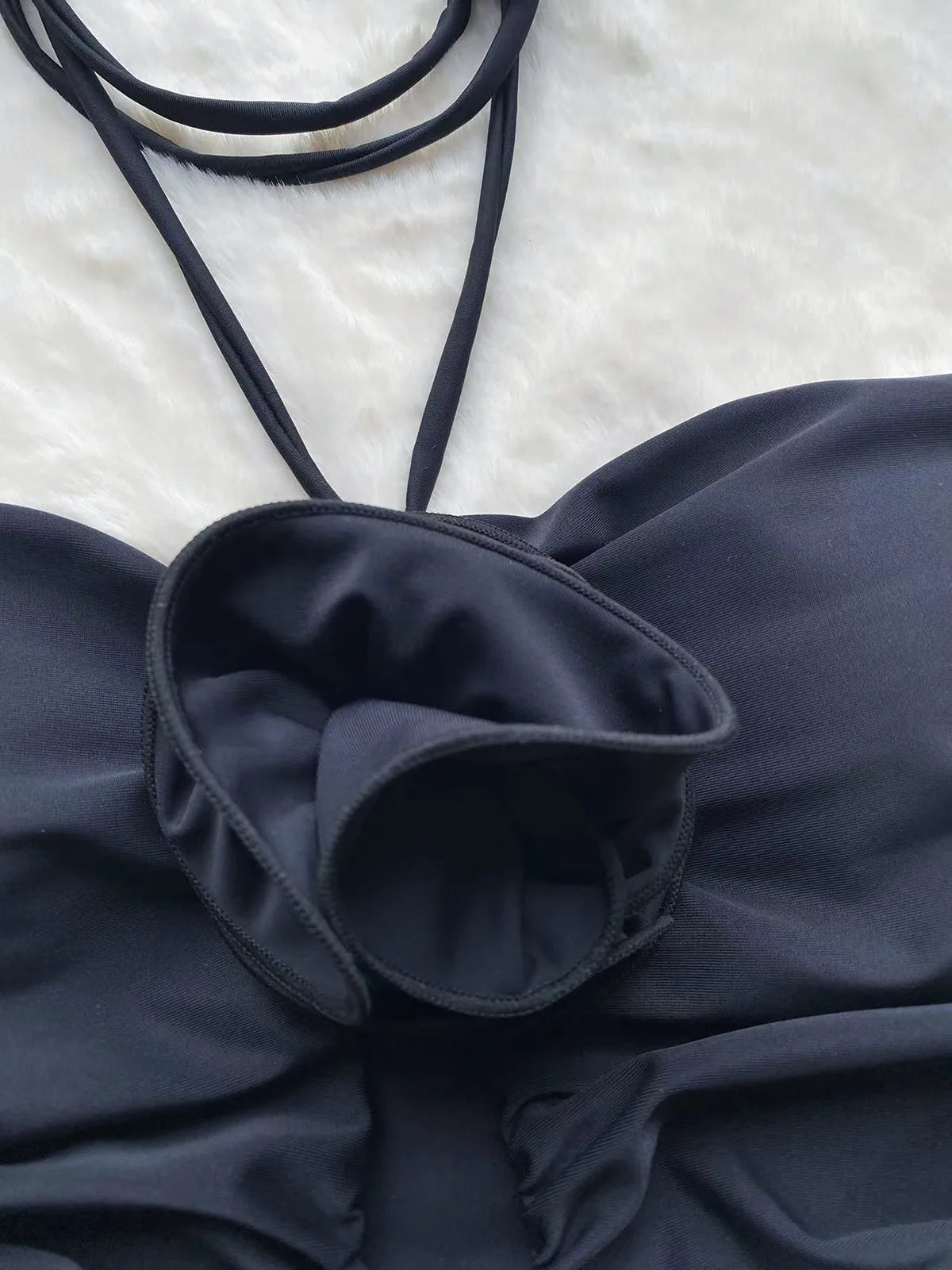 Close-up 3D floral appliqué detail on black monokini — hollow out swimwear women