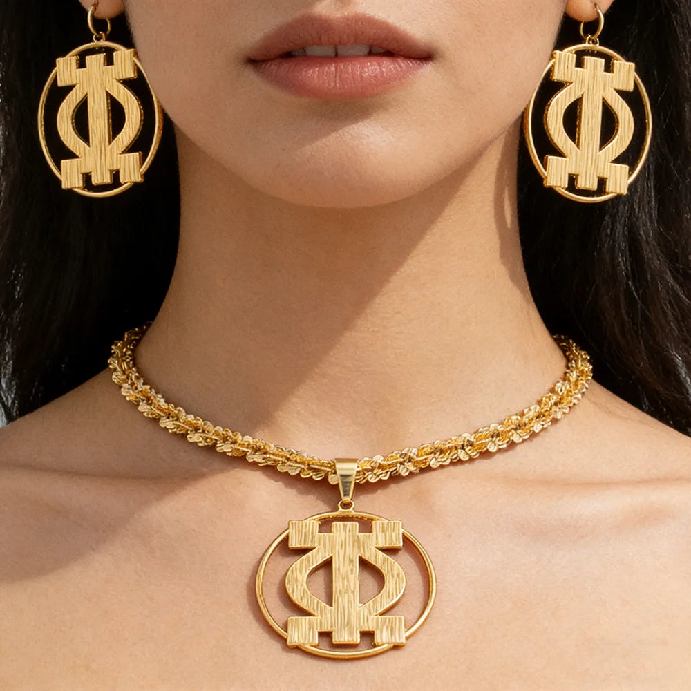 Woman wearing gold statement earrings and twisted rope necklace with African pendant