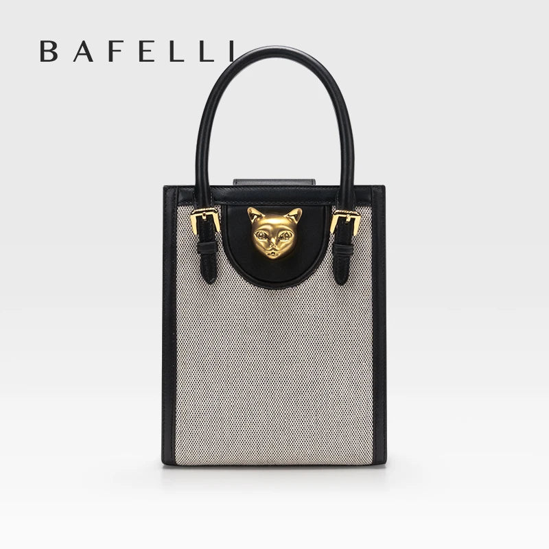Handbag with a gold fox emblem on a white background, featuring the brand 'Bafelli'. Unisex mini tote crossbody bag in split leather with flap pocket and lock closure. Hard box shape and polyester lining. Casual versatile style.