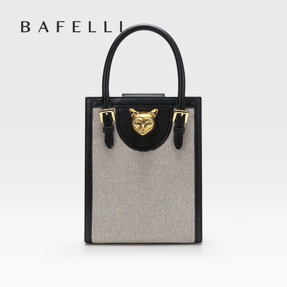 Handbag with a gold fox emblem on a white background, featuring the brand 'Bafelli'. Unisex mini tote crossbody bag in split leather with flap pocket and lock closure. Hard box shape and polyester lining. Casual versatile style.